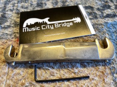MUSIC CITY BRIDGE "STUD FINDER", COMPENSATED WRAPAROUND TAILPIECE, AGED